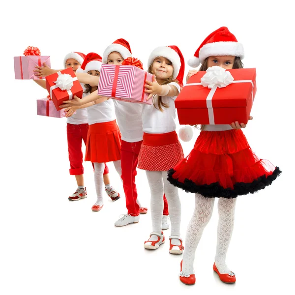 Group of happy kids in Christmas hat with presents — Stock Photo, Image