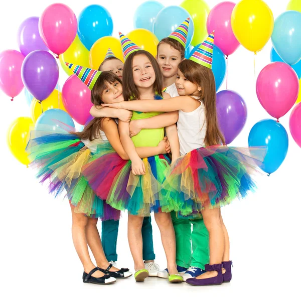 Group of joyful little kids having fun at birthday party — Stock Photo, Image