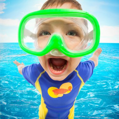 Happy little boy with face mask at sea clipart