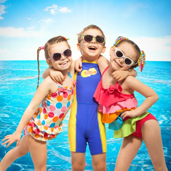 Happy kids in swimsuit at sea — Stock Photo, Image