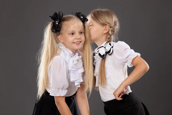Portrait a couple of schoolgirls sharing secrets — Stock Photo, Image
