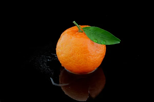 Eine mandarine auf schwarz — Stok fotoğraf