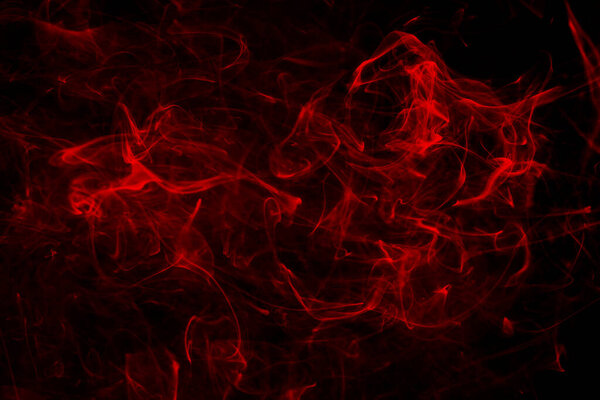 Red abstract light smoke background on black.