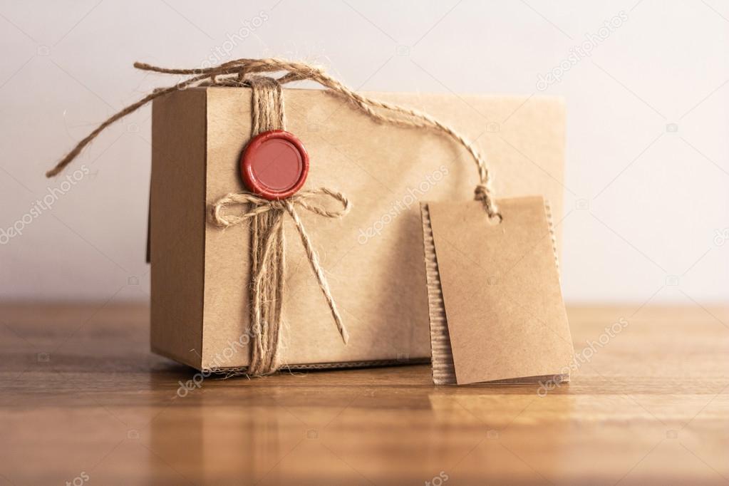 gift box with a red seal on wooden background