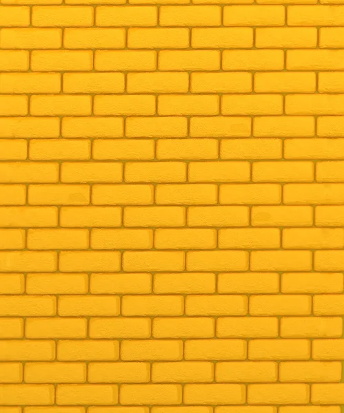 Gele bakstenen muur textuur of achtergrond — Stockfoto