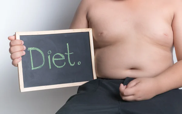 Obese fat boy holding blackboard — Stock Photo, Image