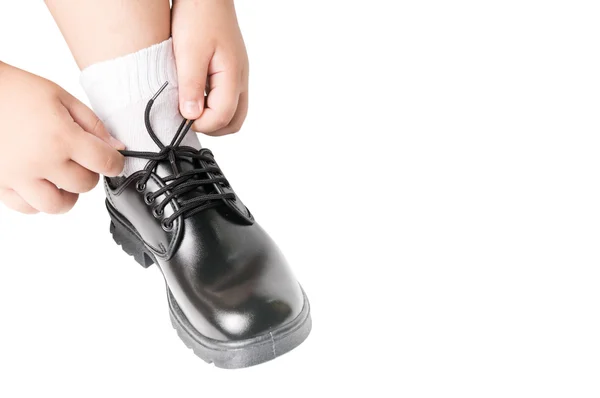 Thai boy is tying the laces student shoe — Stock Photo, Image