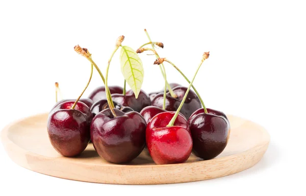 Cherry on wood plate isolated on white — Stock Photo, Image