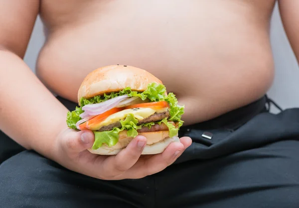 Hamburguesa de queso de cerdo en mano de niño gordo obeso —  Fotos de Stock