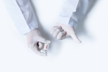 Doktor ya da bilim adamı, beyaz arka plan, ilaç ve uyuşturucu konseptine izole edilmiş salgın aşısı için COVID-19 aşısı içeren beyaz eldivenler verdi.