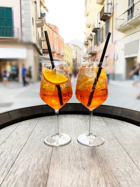 Two glasses with an orange drink on the street background