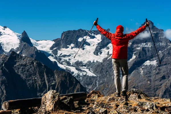 A man traveling in the Caucasus. Mountain sports. Athlete happy finish. Mountain tourism. Walking tour. The journey to the mountains. Nordic walking among the mountains. Copy space