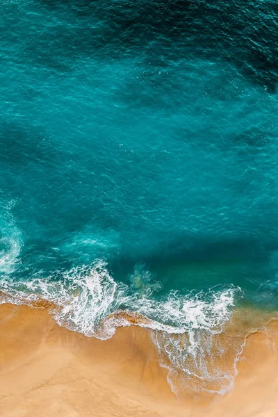 Clean sea and clean beach. Clean beach with yellow sand. Seascape aerial photography. Sea coast, view from the height. Beautiful sandy beach, top view. The ocean and beach. Ocean, waves. Copy space