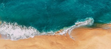 Panorama of a clean sandy beach. Panorama of the beautiful sea coast. Panorama of the sea landscape. Cover for the site. Ocean and beach from a height. The most beautiful beach. Turquoise Ocean.