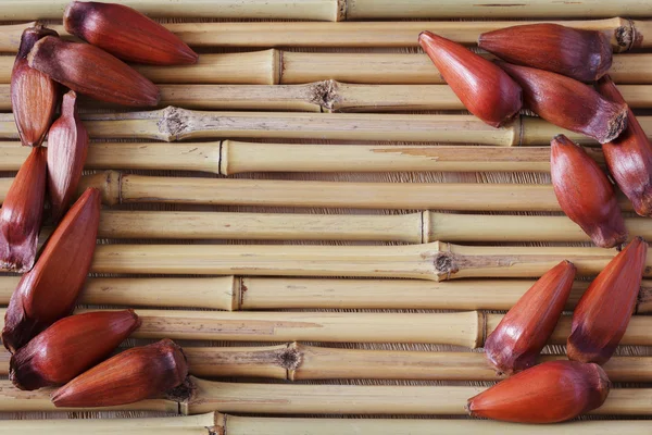 Pinhao - brazilian pine on bamboo board with copy space — Stock Photo, Image