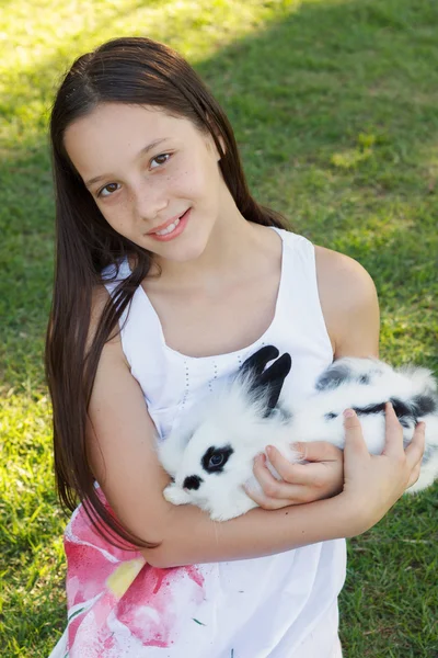 stock image Cute beautiful smiling teen girl holding at white-black rabbit