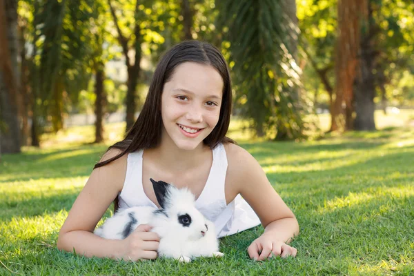 Cute beautiful laughing teen girl with white- black baby rabbit — Stock Photo, Image