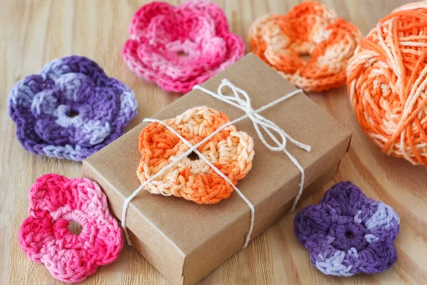 Handmade colorful crochet flowers for decoration of gift with skein