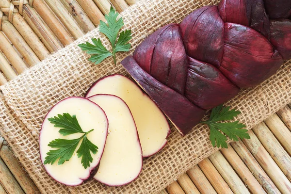 Treccia braided Mozzarella cheese marinated in red wine — Stock Photo, Image