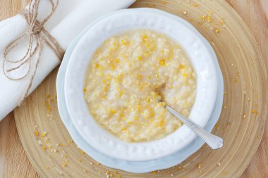 Corn porridge  in white plate clipart