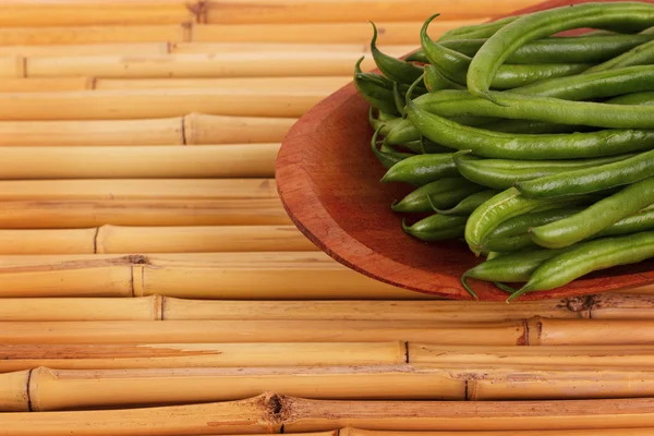 Fresh green beans on bamboo table — Stock Photo, Image