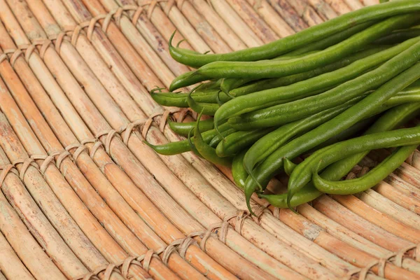 Fresh green beans on wooden table — Stock Photo, Image