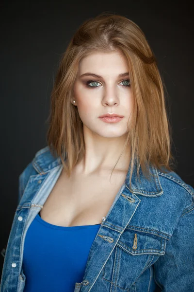 Emotive portrait of a young beautiful girl with curly long hair posing over black background. Perfect skin and hair. Spa salon. Close up. studio shot — Stock Photo, Image