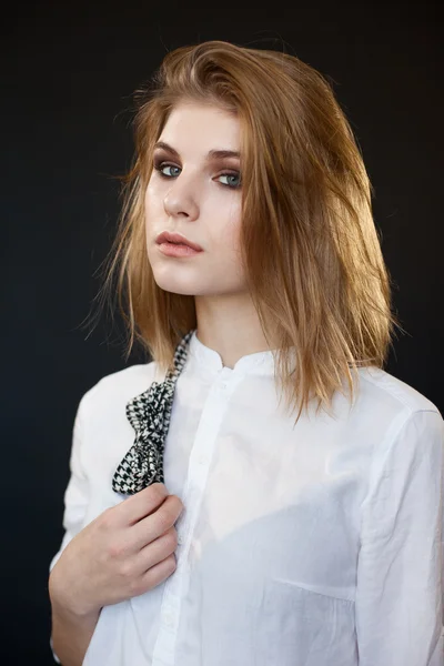 Sexy woman in a white shirt with on dark background — Stock Photo, Image