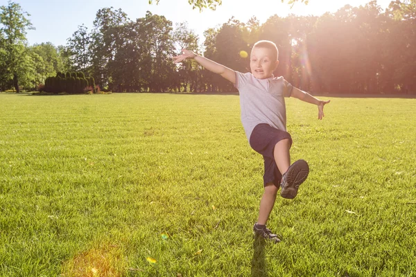 Stock image happy little boy laying on the grass