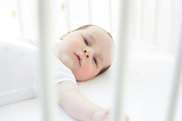 Calm baby in crib — Stock Photo, Image