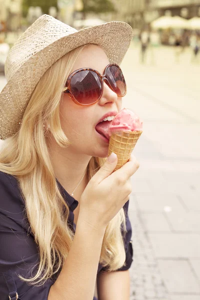 Woman eating ice-cream in the city