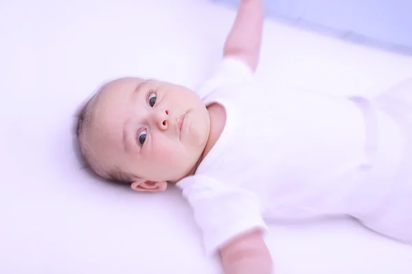 Scared baby in bed — Stock Photo, Image