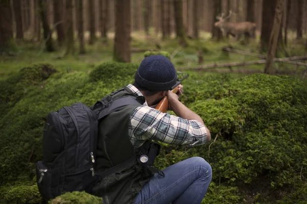 Interracial hunter in the forest aiming at prey — Stock Photo, Image