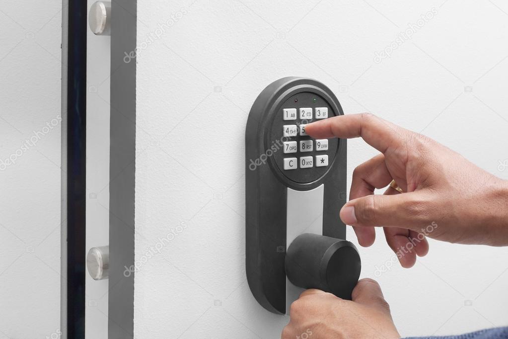 Interracial businessman hand entering security system code