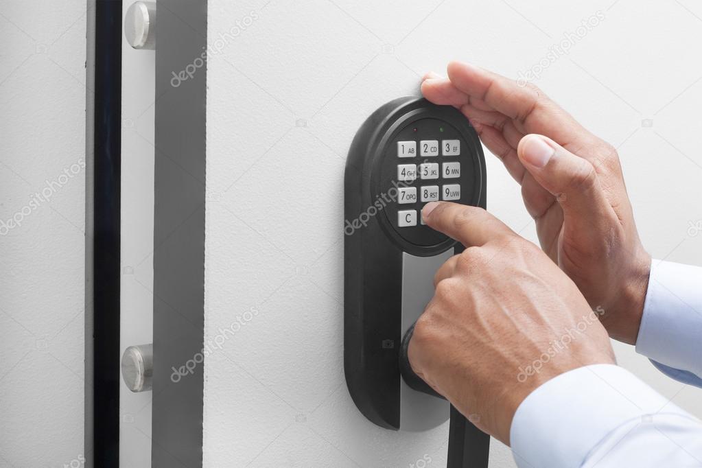 Interracial businessman hand entering security system code