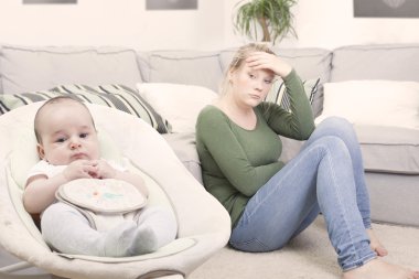 Young new mother suffering from postpartum depression clipart