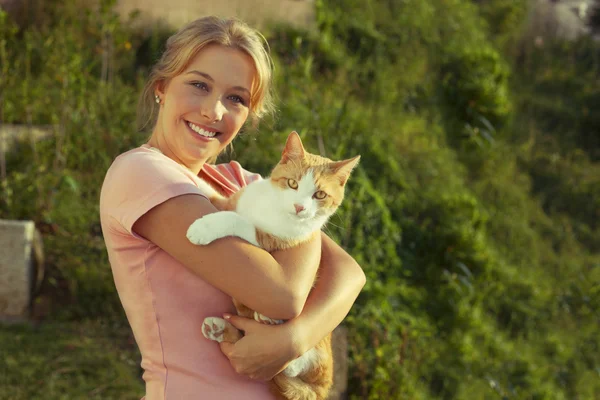 Beautiful blonde woman with red cat — Stock Photo, Image