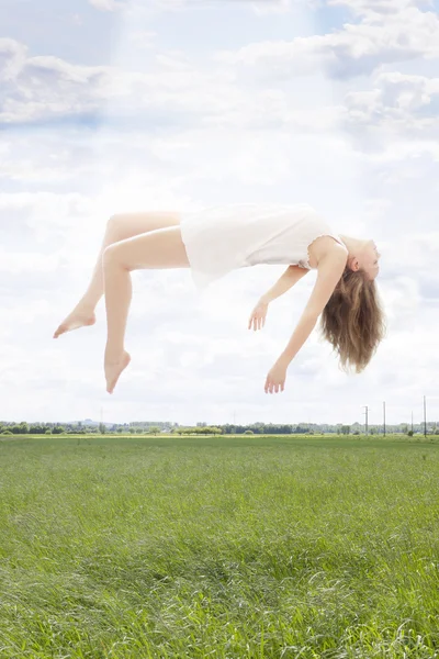 Young beautiful woman floating towards the sky — Stock Photo, Image