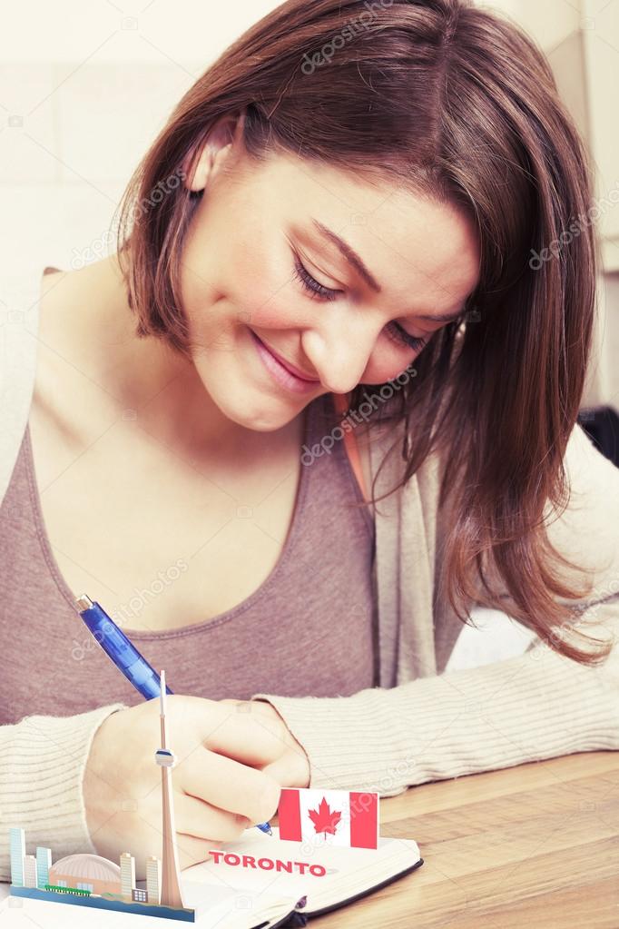 Young woman writing about Canada