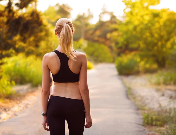 Sport girl standing with her back — Stock Photo, Image