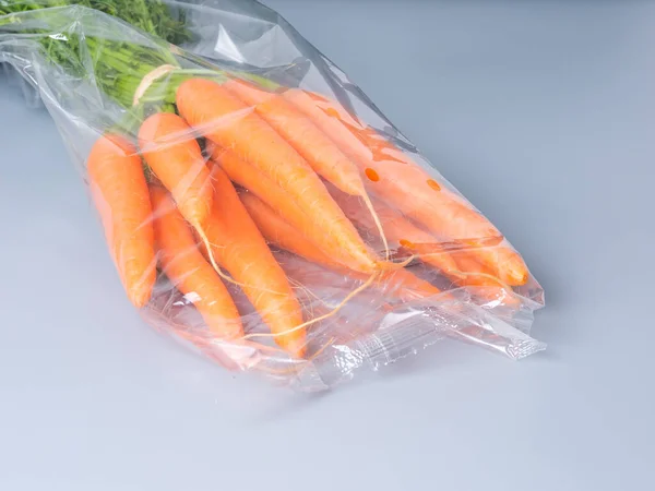 Bunch Fresh Orange Carrots Green Tails Wrapped Plastic Bag Isolated — Stock Photo, Image