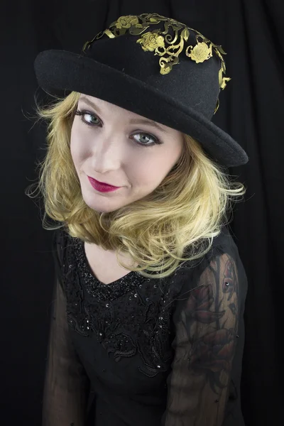 Woman wearing hat with gold trim — Stock Photo, Image