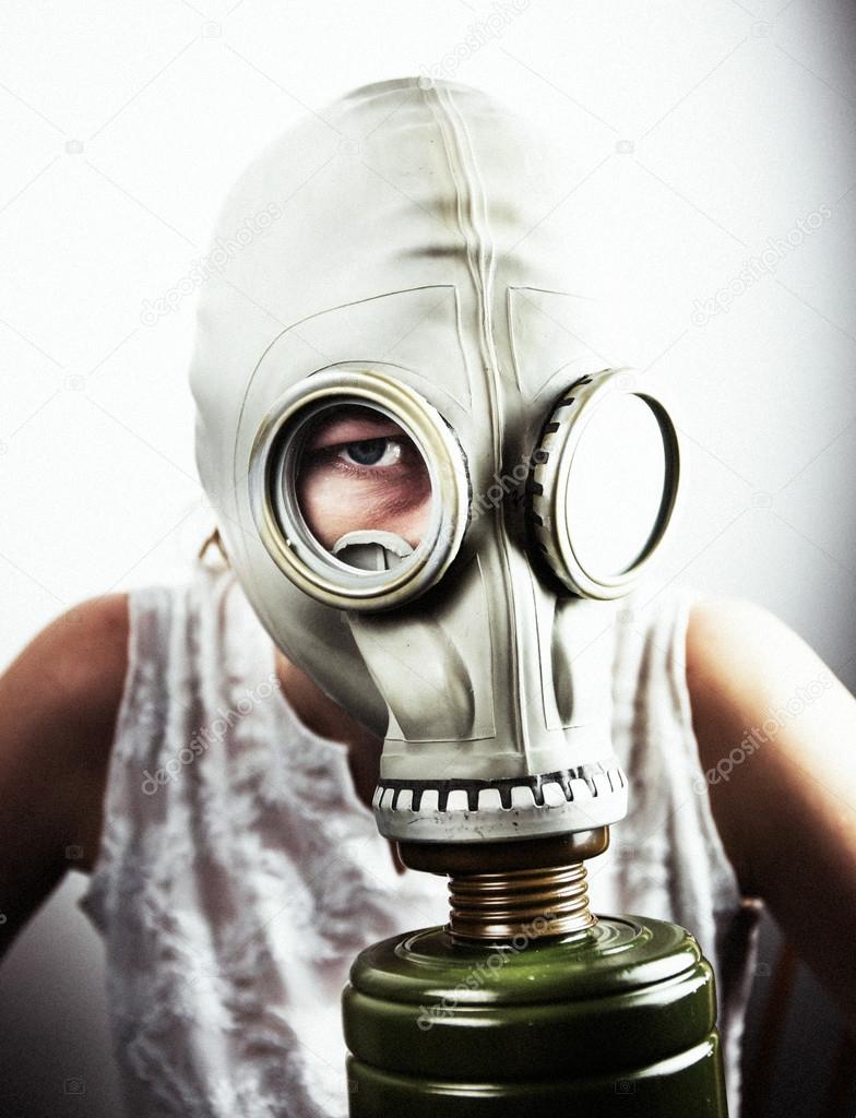 Woman wearing gas mask close-up