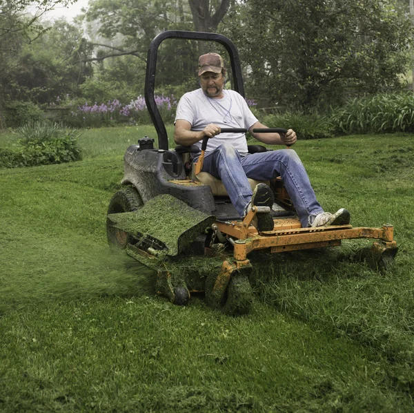 Man cutting grass on lawnmower — Stock Photo © cindygoff 87541610