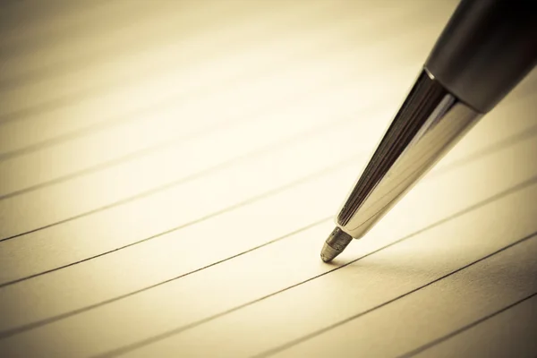 Closeup a pen on notebook with retro effect — Stock Photo, Image