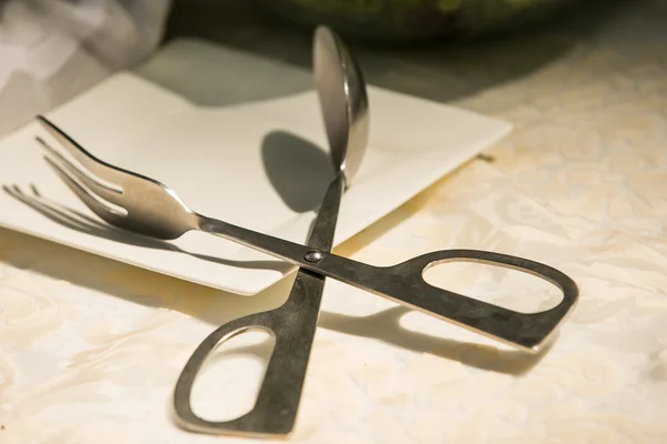 Spoon and Fork headed scissor tongs — Stock Photo, Image
