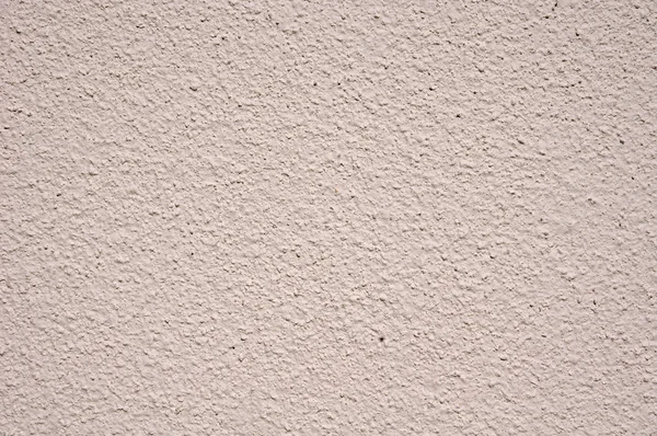 Light pink rough plaster on wall closeup — Stock Photo, Image