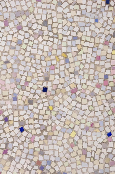 Mosaic of broken tile pieces on wall