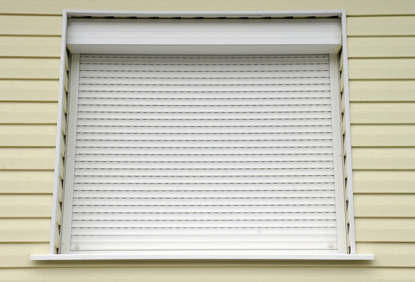 Window with white external blinds house