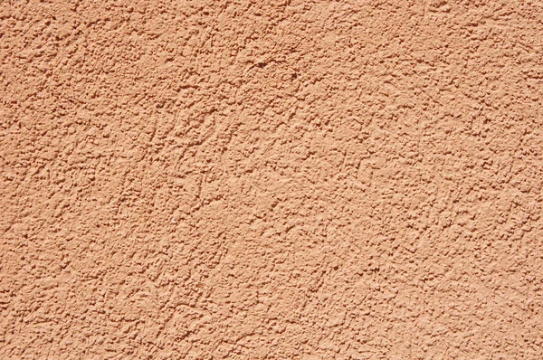 Orange relief plaster on wall closeup — Stock Photo, Image